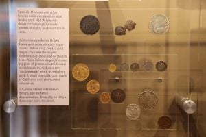 Collection of coins on display representing different forms of tender.