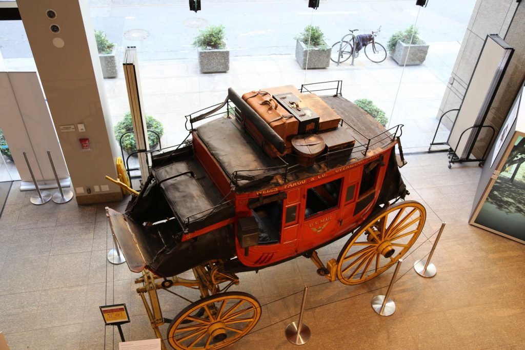 View of the Wells Fargo stage coach and the glass walls separating the museum interior from the street front.  More concrete planters have been added between the street and sidewalk since the theft.