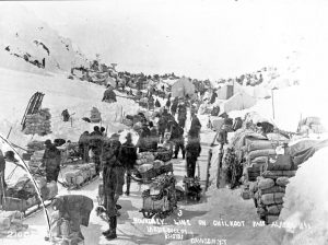 Miners organize provisions along the summit of Chilkoot Pass.  It would take multiple trips to move the massive amount of provisions each miner would need to survive in the forbidding Klondike gold fields.