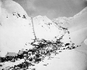 Miners travel the Chilkoot Pass along the Golden Stairs (left) or the Pederson Pass (right)