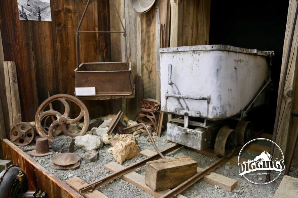 Ore cart, bucket, and assorted mining equipment at the Sumpter Museum And Public Library